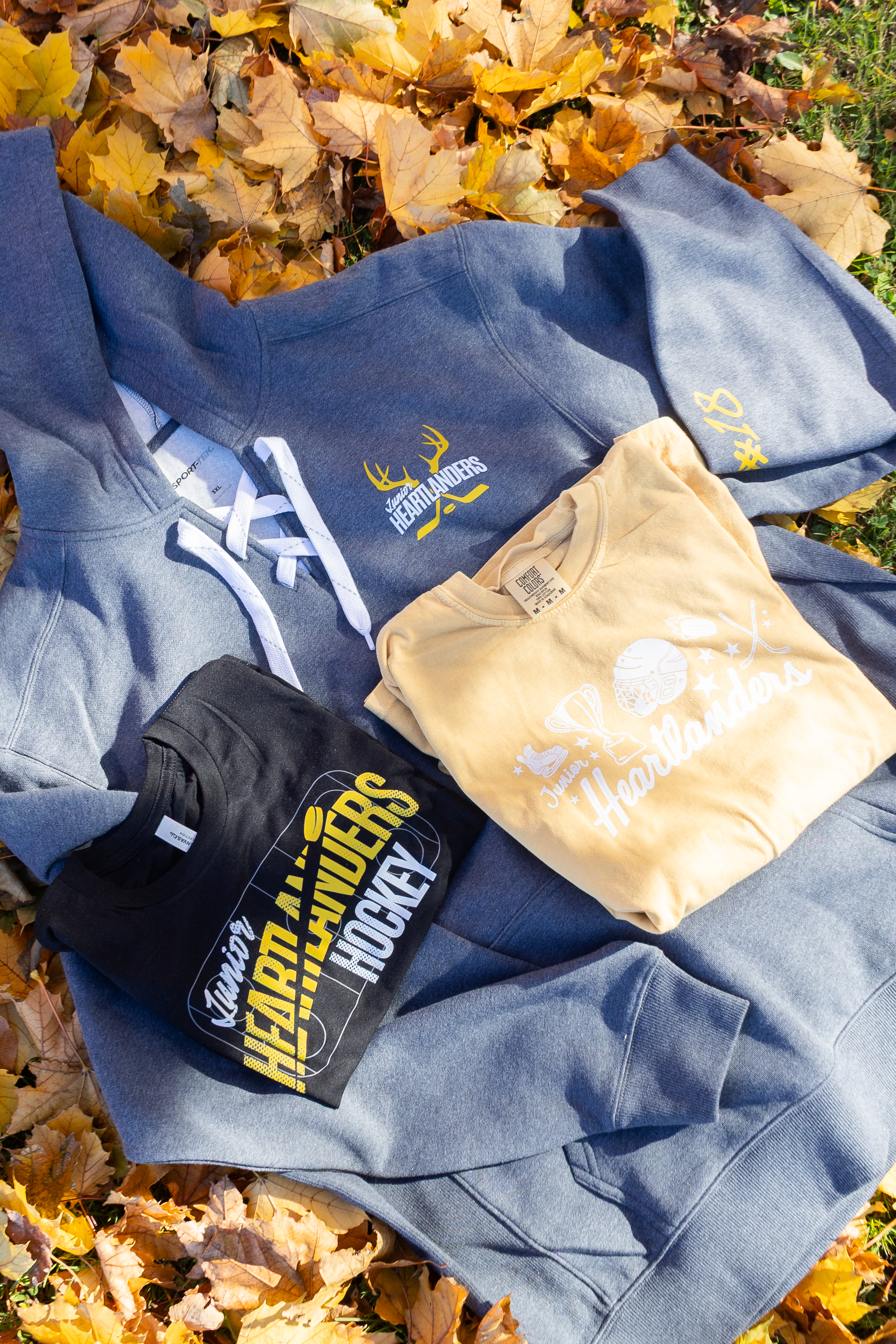 Family of five smiling together at a playground, all wearing matching “Huddle Up for Jackson” fundraiser t-shirts in different colors. Image represents community support and family strength through CAUSETEAM medical fundraising.
